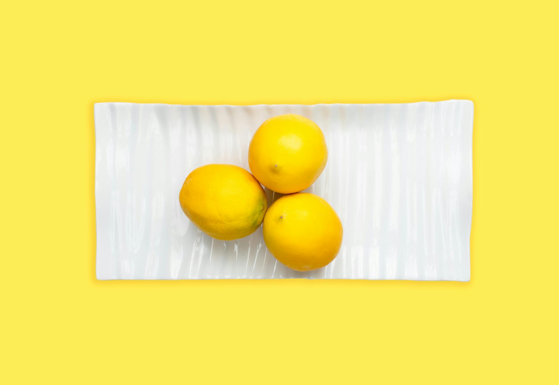 Colorful clitoral vibrators arranged on a bright yellow background, showcasing various designs and styles.