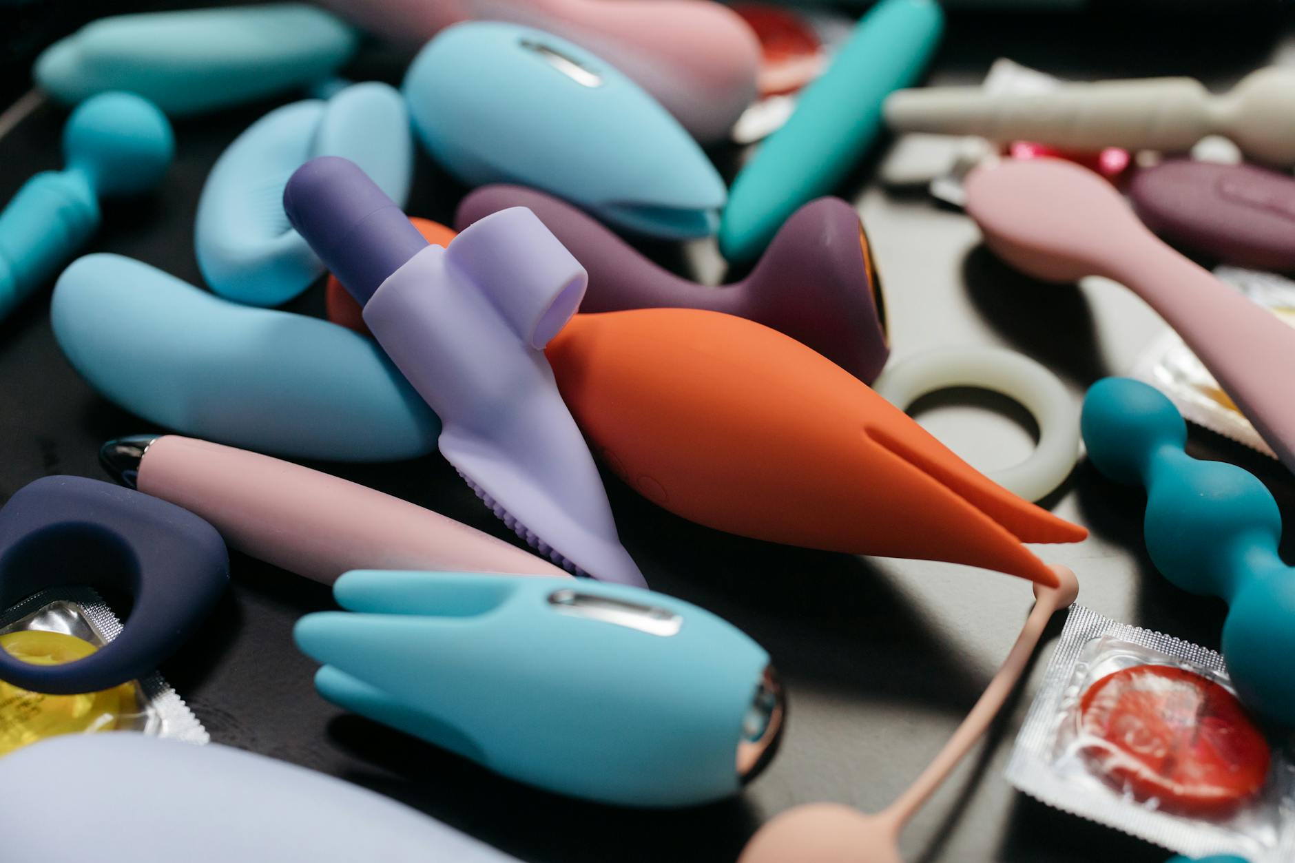 A person holding a clitoral vibrator, representing reclaiming pleasure and self-care after heartbreak