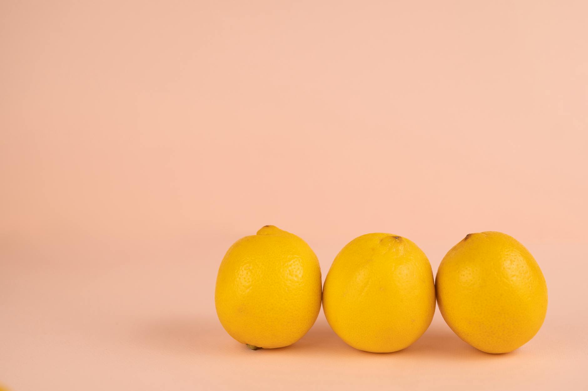 Bright yellow lemons arranged on pastel background, symbolizing fresh exploration without pressure